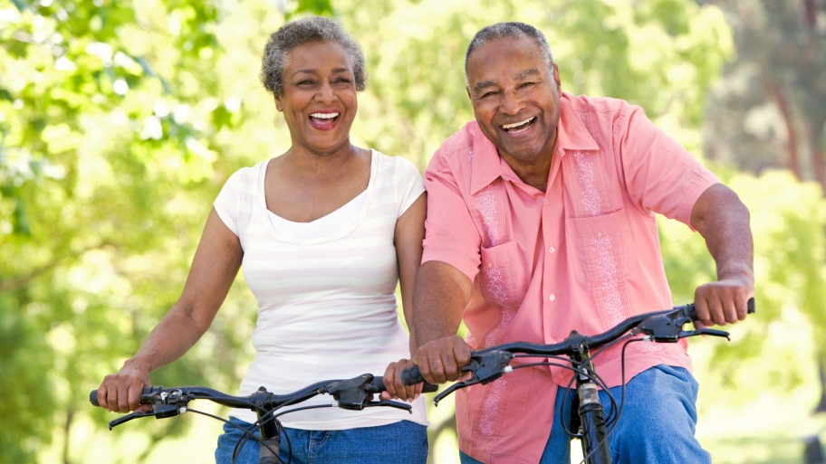 A senior couple enjoy a bicycle ride together.